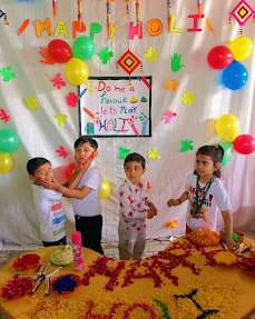 Children enjoying a colourful Holi celebration at TreeHouse Chandkheda